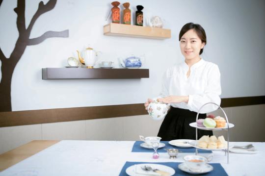 차를 따르려는 여자 사진